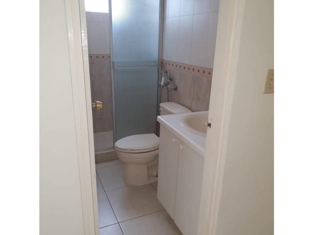 Small bright bathroom with glass shower door PH Victory Towers Panama