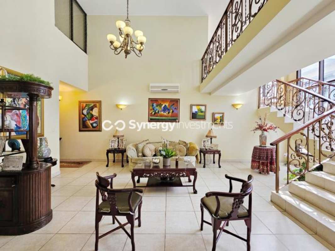 Traditional formal dining room with mezzanine balcony double height ceiling chandelier ocean view penthouse in Punta Pacífica