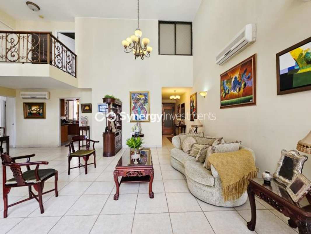 Traditional master bedroom king bed sliding glass doors balcony ocean city views penthouse in Pacific Point Panama