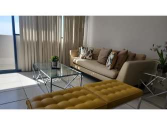 Living room with beige sofa, large windows and tiled floor in PH Fountain View El Dorado Panama
