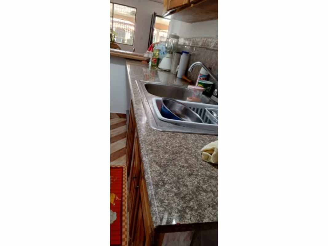 Enclosed porch sunroom with glass block wall, tile floors, plants in Las Acacias Panama