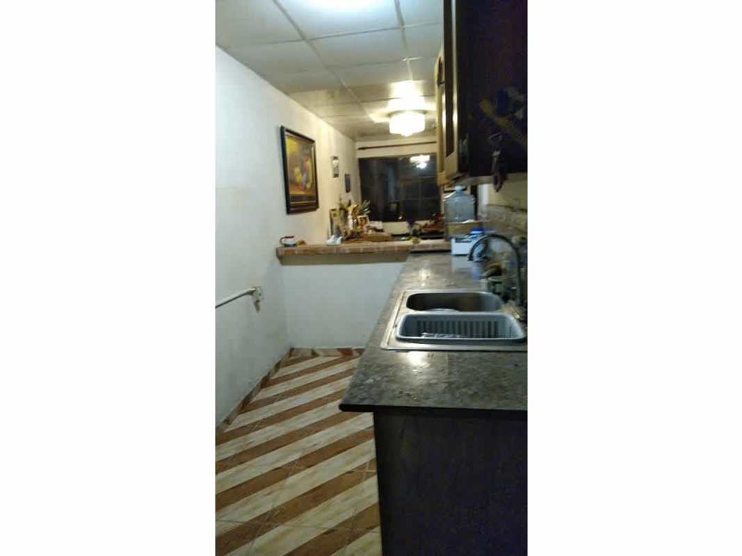 Granite countertop kitchen with double sink and tiled backsplash in Las Acacias Panama City