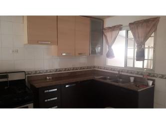 Contemporary kitchen L-shaped counter white brown overhead cabinets Villas El Carrizal