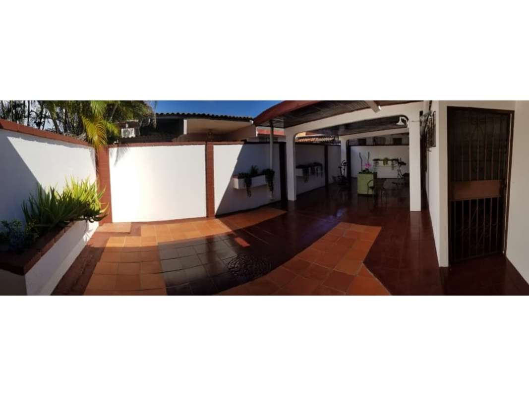Sunny tiled courtyard with planters, white walls, and shaded area house for sale Panama
