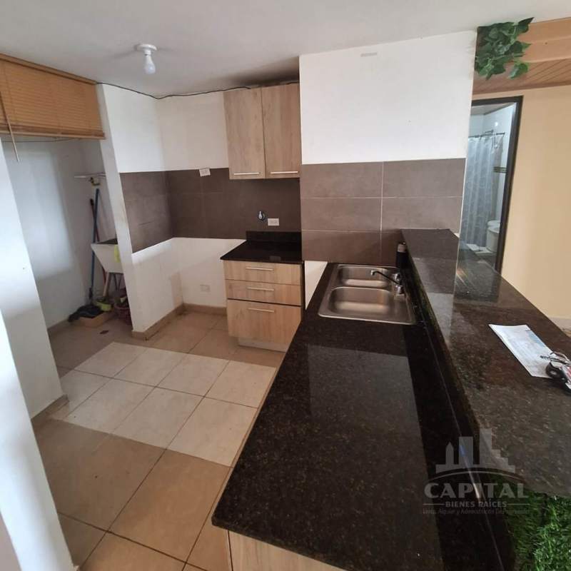 Kitchen with granite counter brown cabinets tile floor laundry nook PH Villa Andalucía Panama City