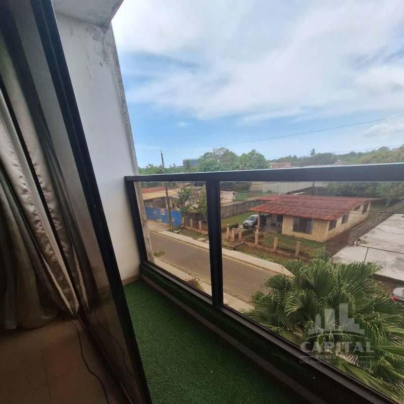Small balcony with glass railing artificial green carpet overlooking neighborhood Las Acacias Panama