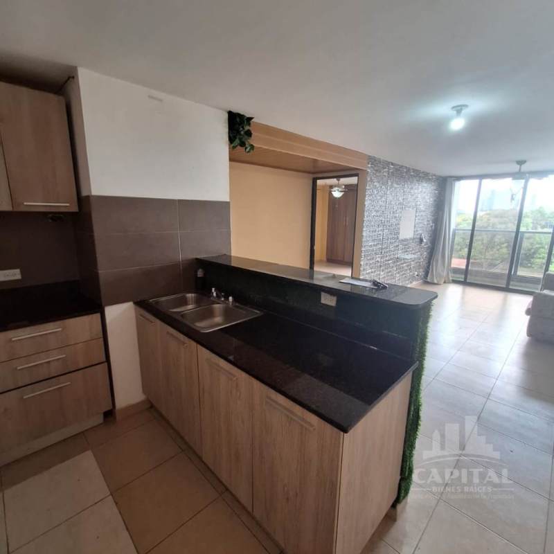 Bright living room with tiled floor and sliding door to balcony in Las Acacias Panama