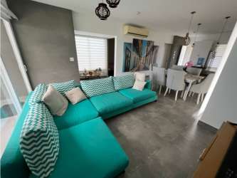 Bright open plan living dining area with ceiling fans at Villa Mamey Punta Barco Panama