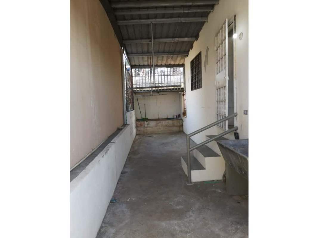 Kitchen with wooden cabinets, tile backsplash in commercial residential house Villa de las Fuentes Panama