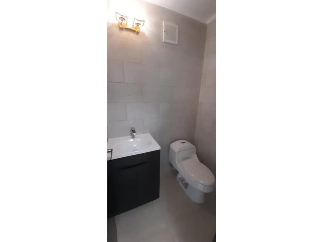 Modern kitchen with granite countertops and dark wood cabinets PH Country Heights Panama City