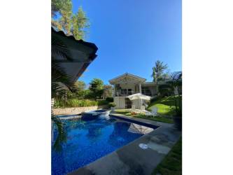 Bright bedroom with two beds, split AC unit, large windows and minimal decor Santa Clara beach house