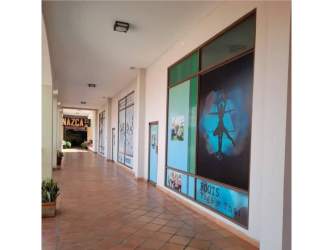 Covered pedestrian walkways with storefronts at The Village Mall Coronado Panama