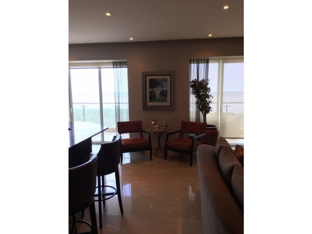 Modern living area with floor-to-ceiling windows leading to balcony at PH Zeus Panama