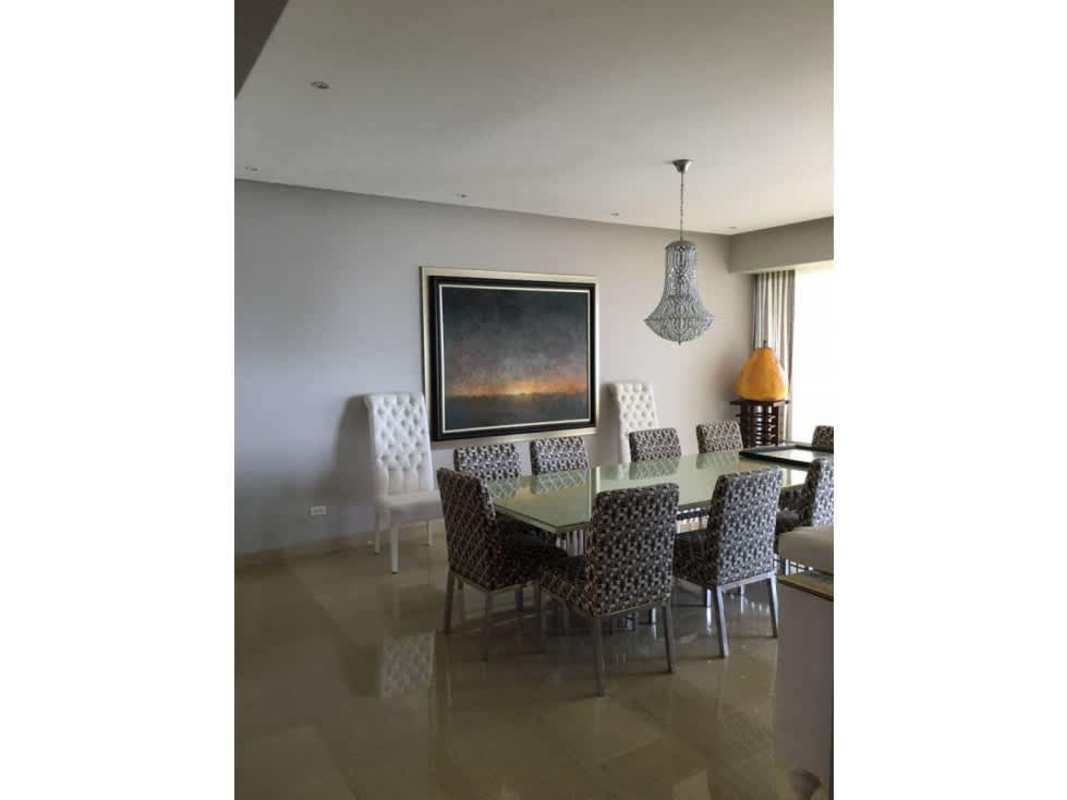 Elegant dining area with modern decor, chandelier, and art pieces at PH Zeus Costa del Este