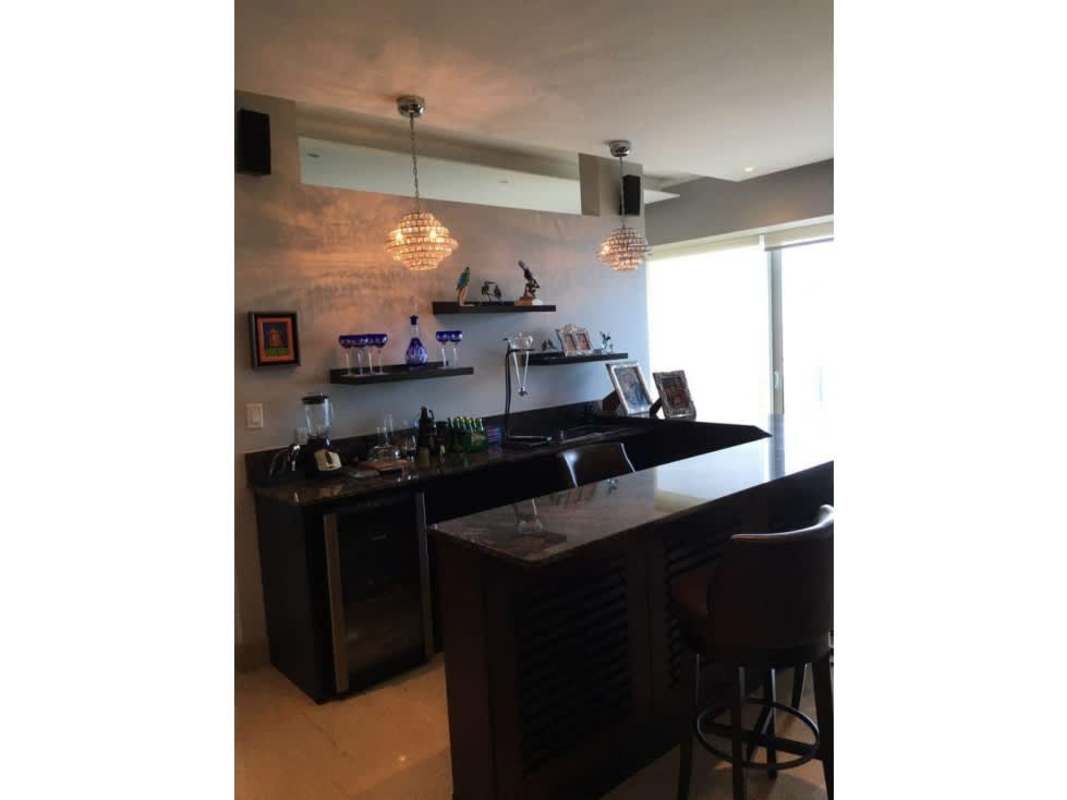 Stylish home bar with granite counter, pendant lights and floating shelves at PH Zeus Panama