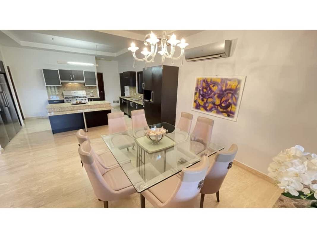 Open concept dining and kitchen with island, granite counters in Sunset Coast Costa Sur Panama