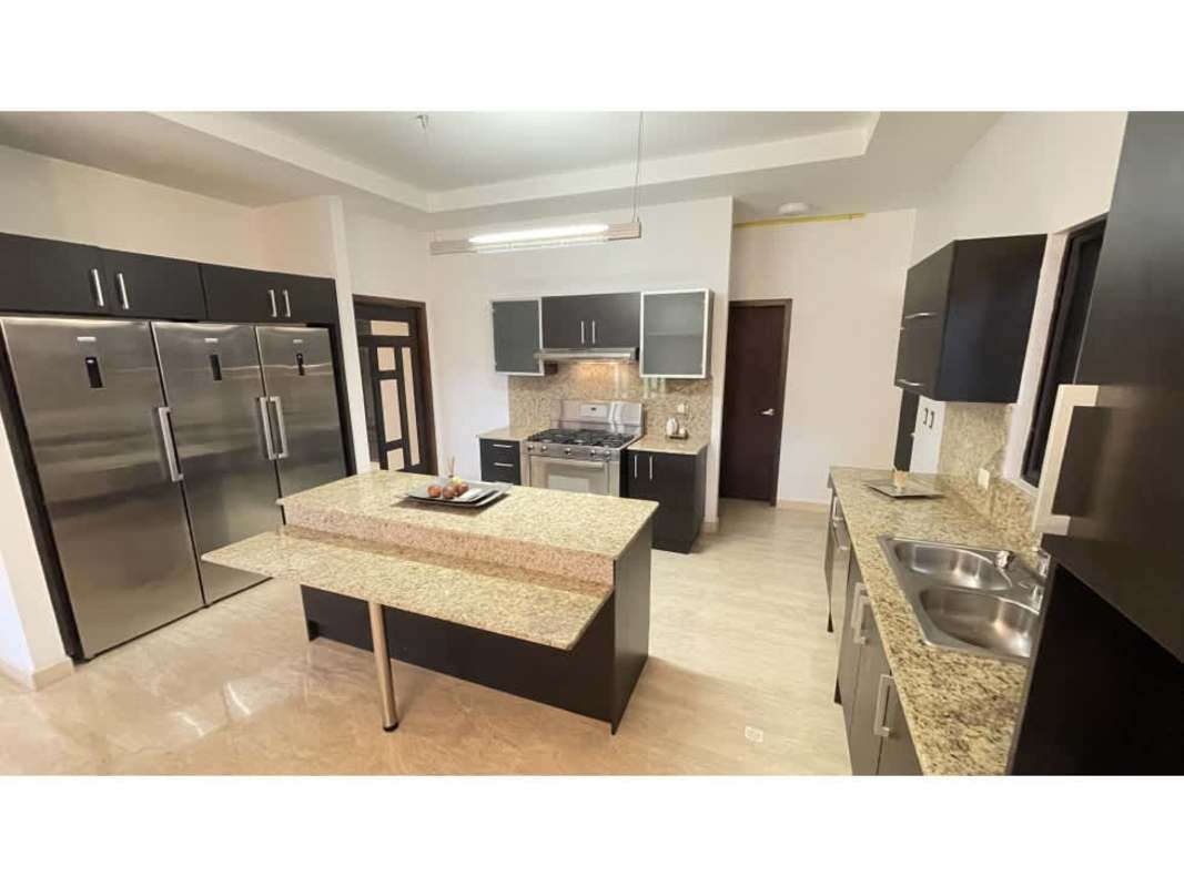 Contemporary kitchen with granite counters, island and double fridge in Sunset Coast Costa Sur