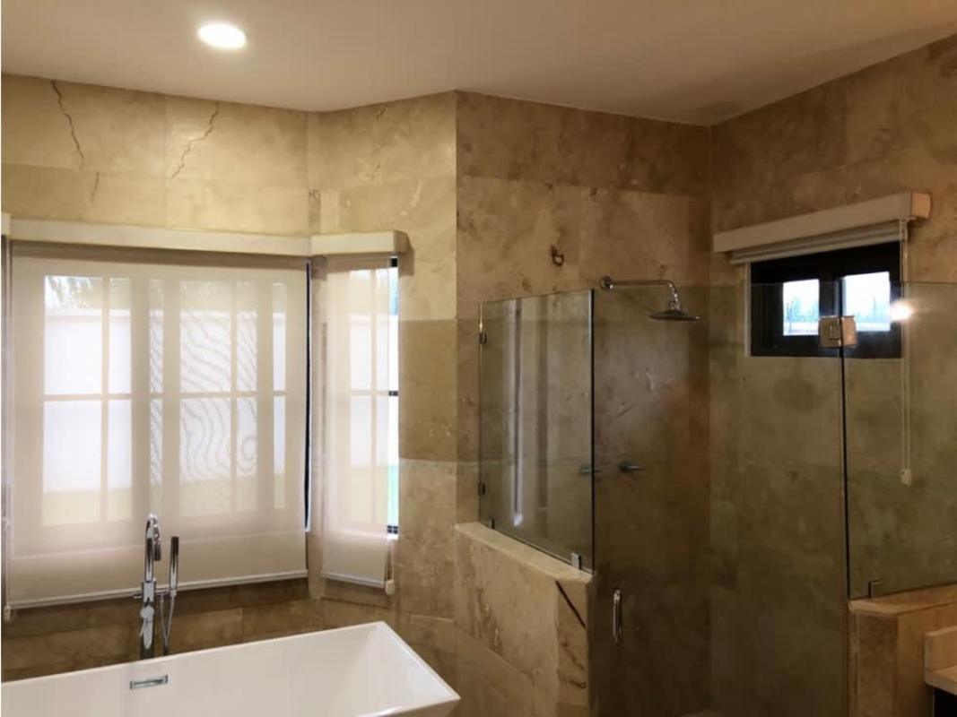 Luxury bathroom with marble tile, glass-enclosed shower and large windows Costa Sur Panama