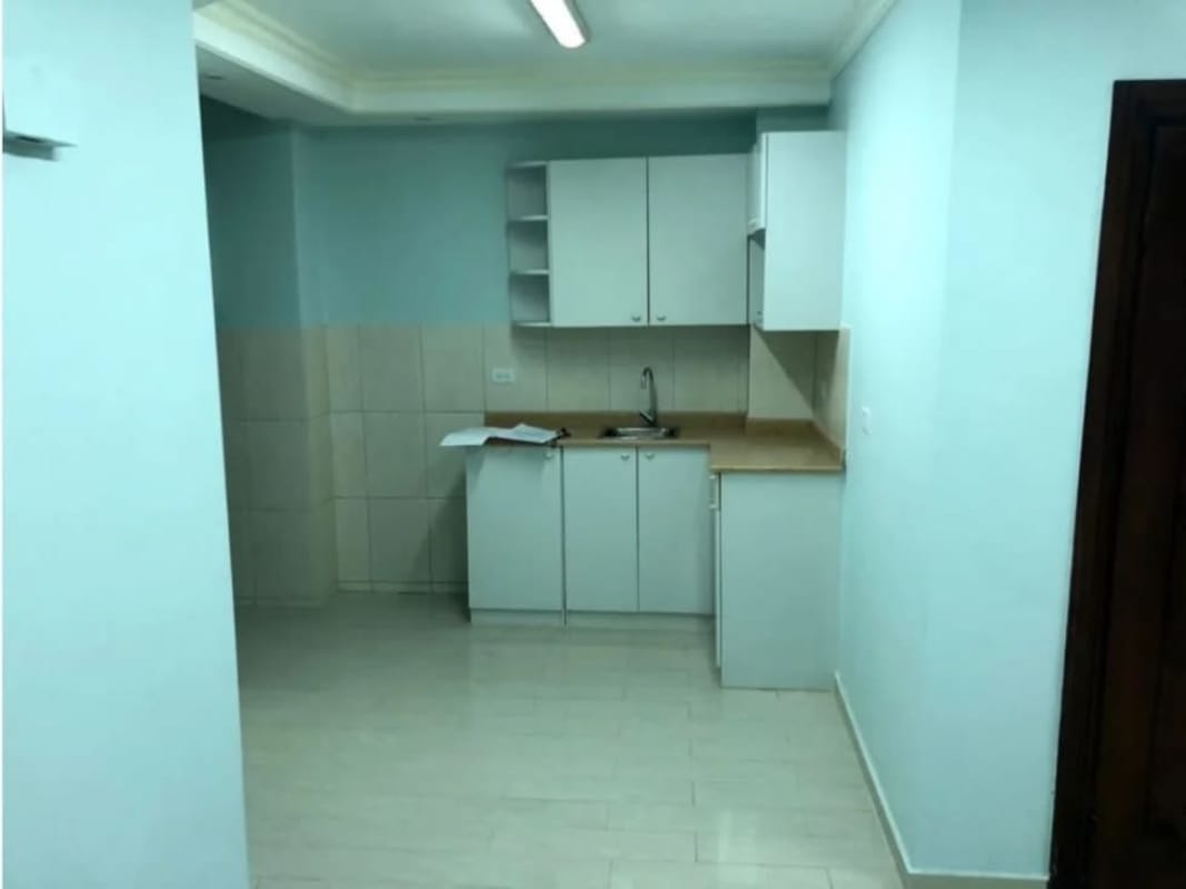 Interior utility area with sink, cabinets next to restroom inside commercial unit Santa Elena Panama
