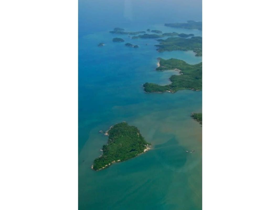 Aerial view lush green island surrounded by clear turquoise ocean and sandy coastline Las Perlas Panama