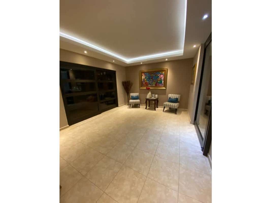 Elegant sitting area with bright windows, striped chairs, tiled floor at Palmeras del Este Costa del Este Panama