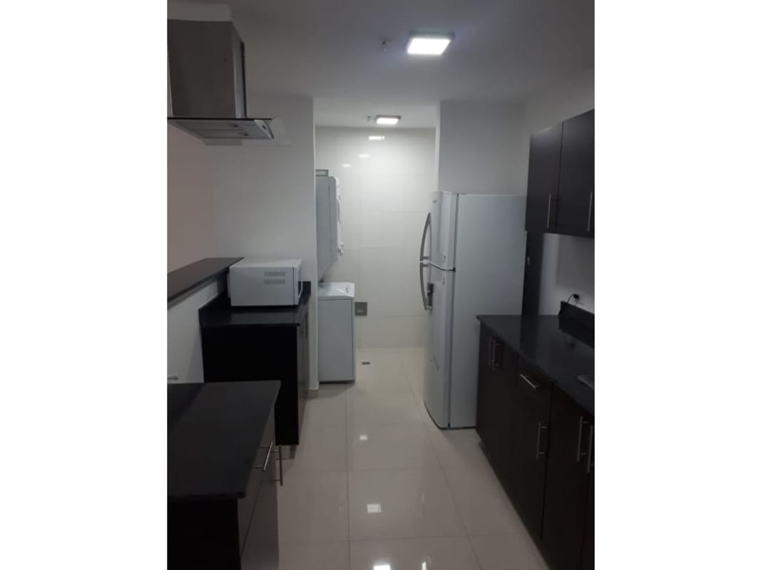 Modern kitchen with dark wood cabinets, tiled floor, and stainless sink PH Macedonia Tower El Ingenio