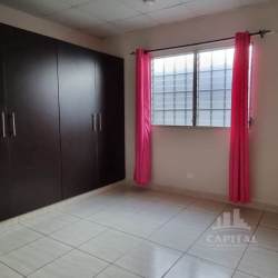 Bedroom with closet, tiled floor, window in affordable Panama house Villas del Sol
