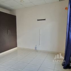 Bedroom space with tiled floors and window in Villas del Sol Arraiján Panama house