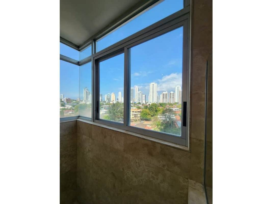 Modern kitchen with large windows and city skyline views at PH Terrazas del Pacífico in San Francisco Panama City
