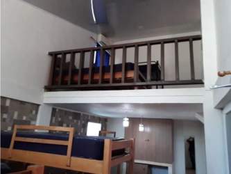 Large covered patio area with hammocks and outdoor dining next to swimming pool in Panama beach house