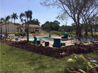 Modern bathroom with double sink vanity, large mirror, floral wallpaper in River Valley home Panama Pacifico