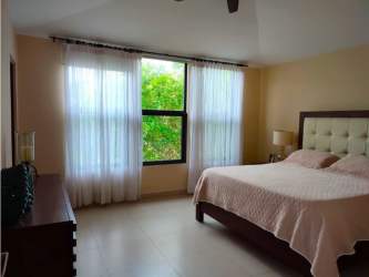 Living room opening onto patio and green garden in River Valley Panama Pacifico