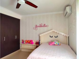 Children's bedroom with playful decor, ceiling fan, large windows in River Valley Panama Pacifico home