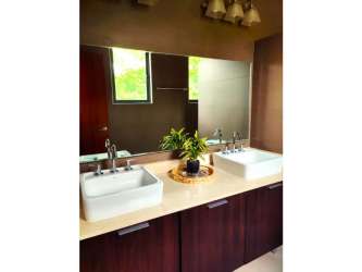 Living dining space with glass doors to patio and garden River Valley home Panama Pacifico