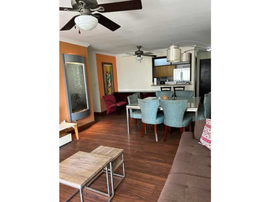 Kitchen with granite countertops and wood cabinetry in PH Sunrise Tower apartment Obarrio