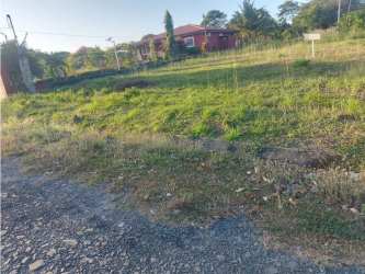 Wide grassy lot with red roof single-story home in secure Coronado community Panama