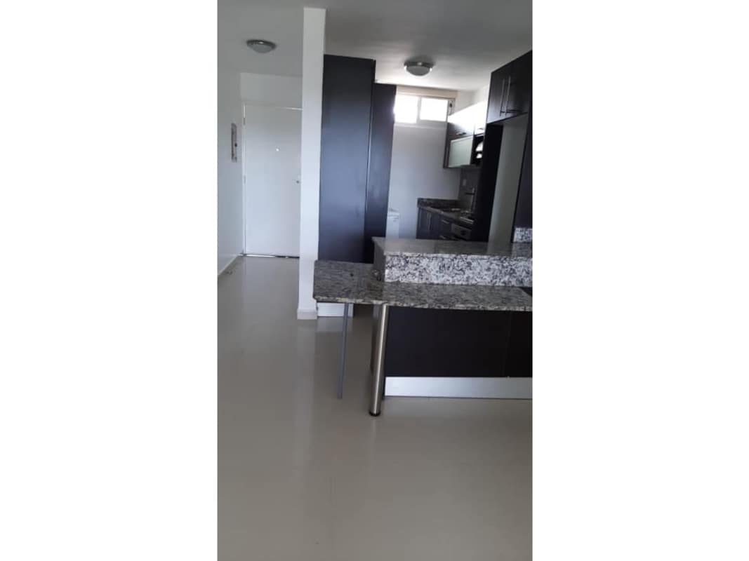 Dark cabinetry, granite breakfast bar and modern fixtures PH Altamira Gardens Ancón Panama