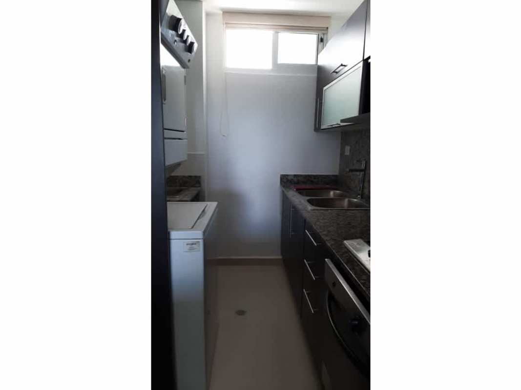 Galley kitchen with granite countertops, stainless sink, oven and cabinets in PH Altamira Gardens Ancón Panama