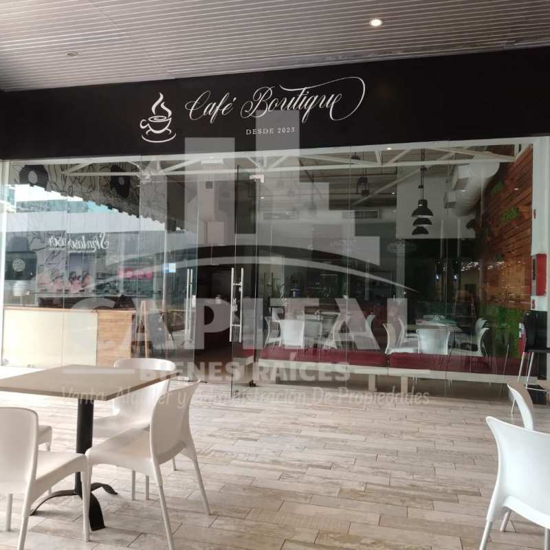 Open commercial interior with glass walls, seating, and city views in Panama Strip Mall