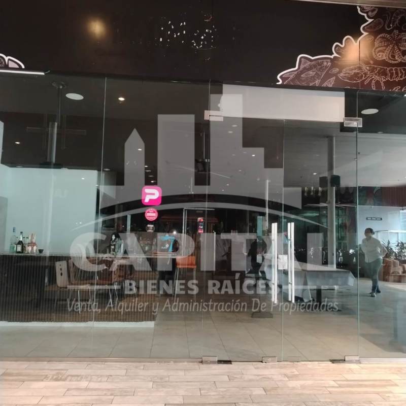 Restaurant interior with mural, tables, and bar in modern Panama commercial plaza