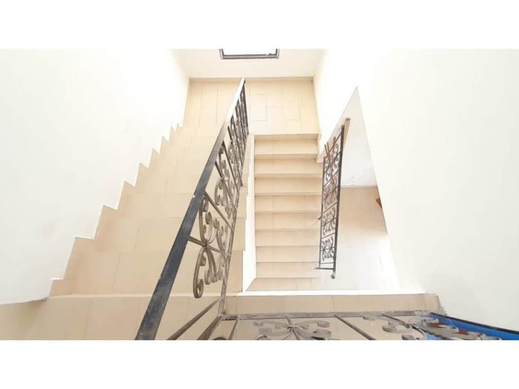 New two-story home indoor staircase with beige tiles and dark iron railings in El Doral Costa Sur Panama