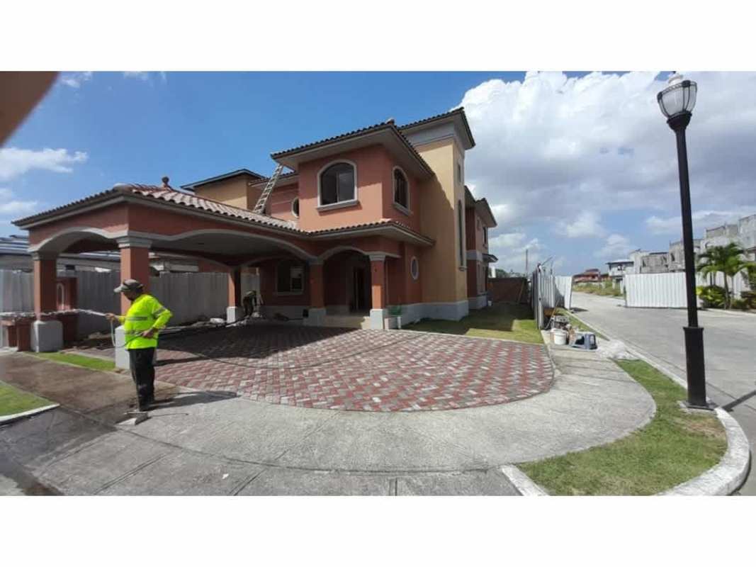 Entrance gate with tile roof, arches and security post at El Doral Costa Sur Panama City