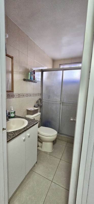 Bathroom with shower, granite sink vanity, tiled walls at PH Victory Tower Panama