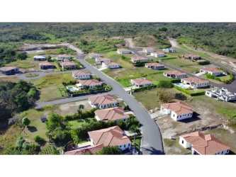Modern country kitchen with granite counters, light wood cabinets in Hacienda Pacífica Panama