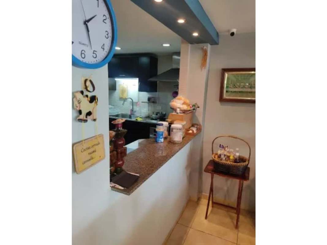 Contemporary kitchen with granite countertops open pass-through in Betania Panama house