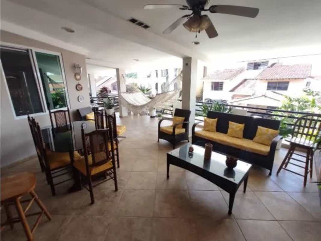 Covered outdoor balcony and patio with seating and garden view Villa de las Fuentes Betania Panama
