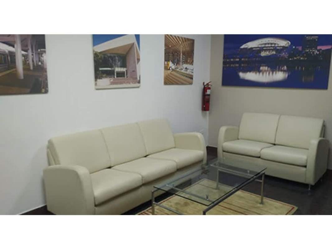 Modern waiting room with cream sofas and glass coffee table in Banco General Tower Panama City