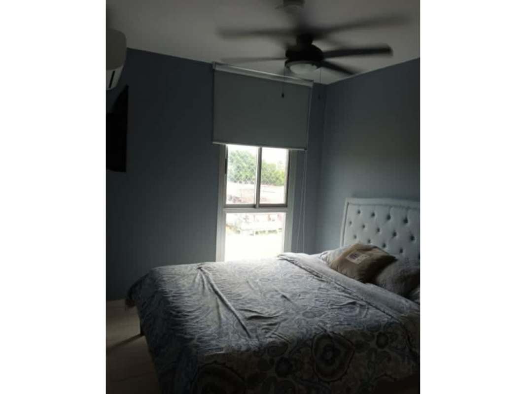 Furnished living room with large window access to balcony and modern tile flooring in PH Torre del Este Don Bosco Panama