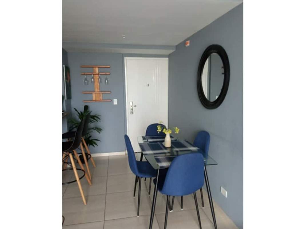Compact open dining area next to equipped kitchen with appliances in PH Torre del Este Don Bosco Panama