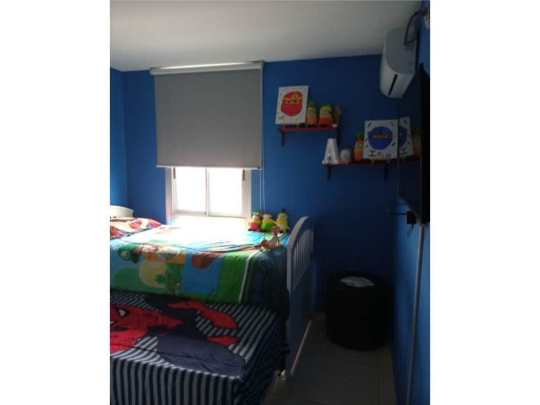 Children's bedroom with colorful bedding and blue themed decor in PH Torre del Este Don Bosco Panama